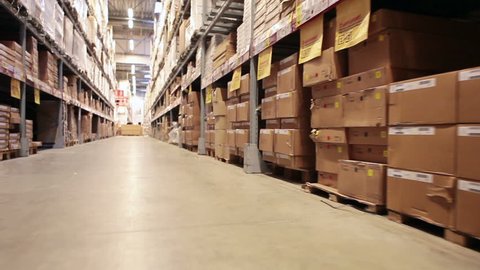 Moving camera along warehouse shelves with goods and materials