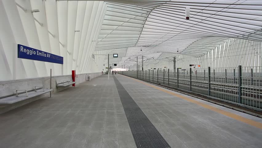 high-speed train passes inside the station of Reggio Emilia