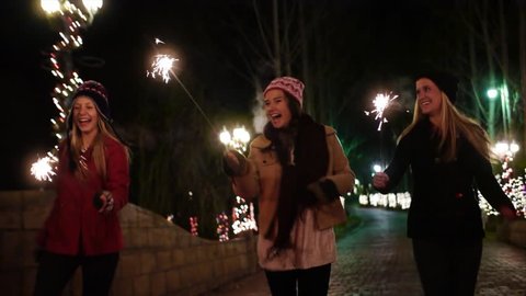 Teen Girls w/Sparklers Run Out The Gate Of A Winter Wonderland – Slow Motion