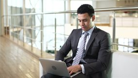 Young businessman communicating via laptop