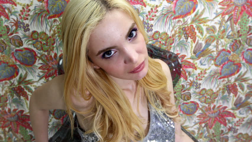 Close-up head shot of beautiful sexy disco dancer against an vintage flower wallpaper useful for vj loops, events, clubs and parties

