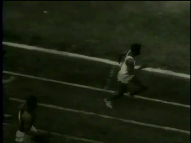 Elias Gilbert from Winston-Salem University wins NCAA 110 Meters Hurdles at Penn Relays, Franklin Field, Philadelphia, PA circa 1958 - MGM PICTURES, UNIVERSAL-INTERNATIONAL NEWSREEL, USA. Slow motion.
