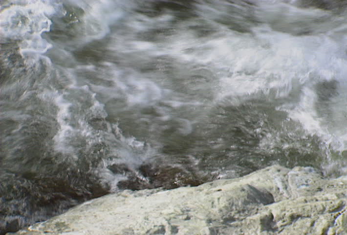 Pan across fast-moving water on a river.