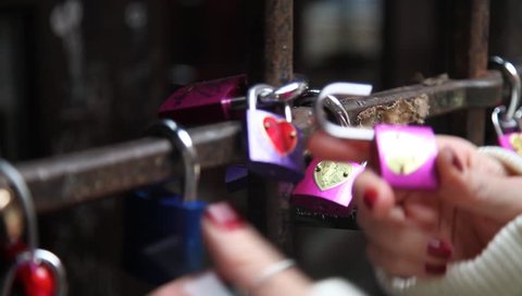 tourist declaring her love on a lock in the House of Romeo and Juliet in verona