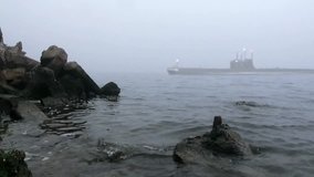 Submarine sails past coast mist - Powered by Shutterstock - Get 15% off with code: PIKWIZARD15