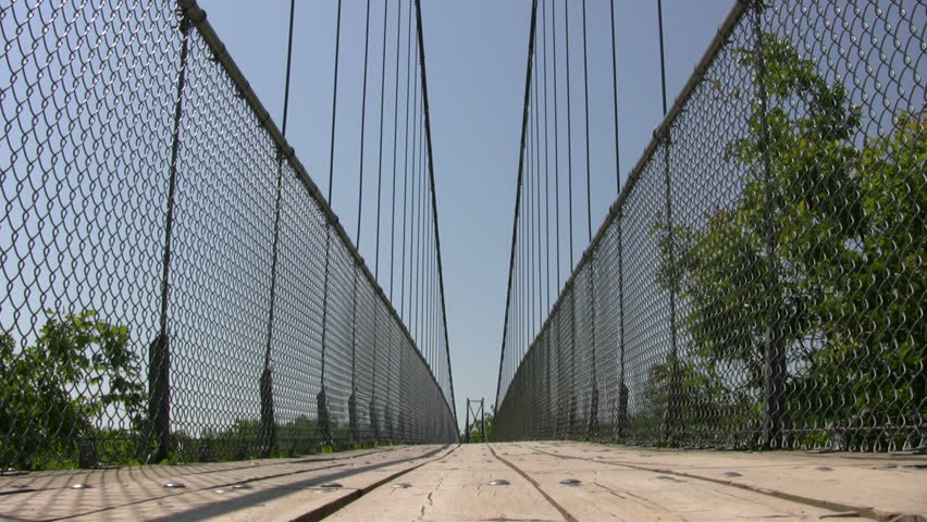 A pedestrian suspension bridge crosses over the treetops. This is Ontario