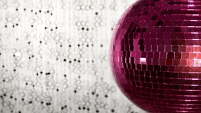 funky pink mirror ball spinning with patterns of light. useful for vj loops, events, clubs and parties
 - Powered by Shutterstock - Get 15% off with code: PIKWIZARD15