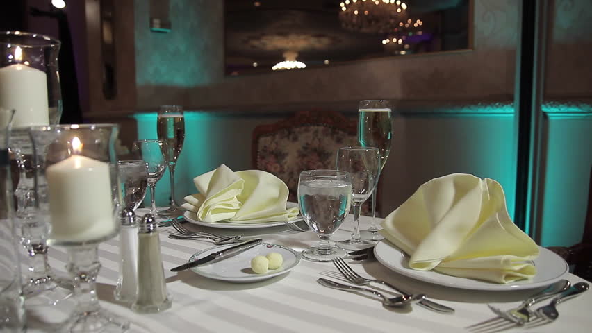 Set table with champagne, napkins, and place settings. Royalty-Free Stock Footage #5503085