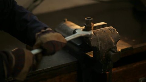 Screw Unscrewing in an old metal Workshop