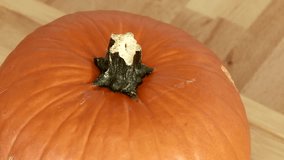 Video footage of cutting a pumpkin in a kitchen for soup