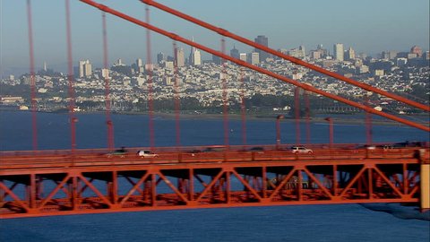 San Francisco City Bridge. The scene shows the city of San Francisco. The shot focuses on the downtown portion of the city. Traffic is shown moving on the Golden Gate Bridge.
