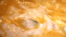 Closeup video of an omlette being cooked in a frying pan. Selective focus.