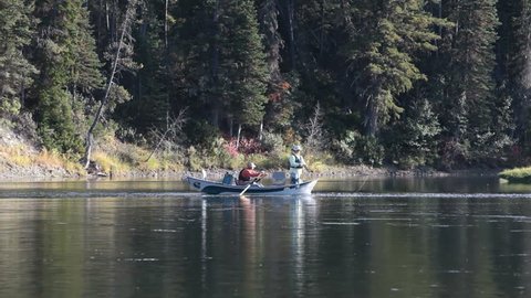 Snake River inside Grand Teton National Park, Wyoming. Oar boat fishing in an outdoor adventure. Fun in the wilderness area. Fly fishing and recreation with a guide. 
