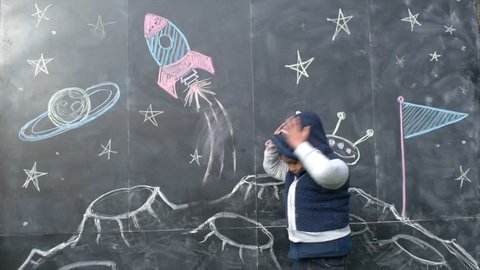 Cute Boy With A Space-Themed Chalkboard Drawing
