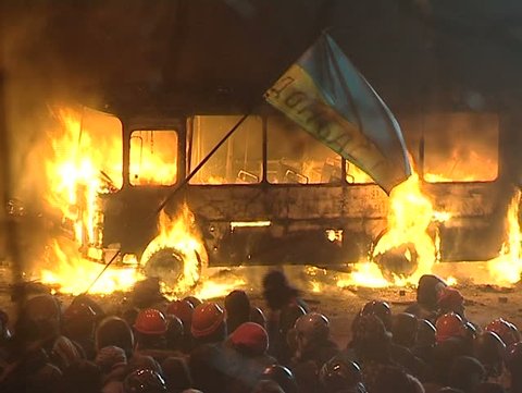 KIEV - JAN 20 2014:20. January. Ukraine in 2014. Kiev.Burning bus, protesters clash with police