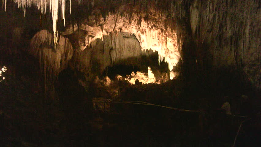Video of Carlsbad Cavern National Park in New Mexico. Two people walking by. Inside cave at about 750 feet underground. Colorful formations with lights. Rekindle Photo