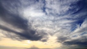 Sunset through layers of clouds as moving background. Timelapse of Clouds at sunset. HD wide-angle, time lapse clip. 
