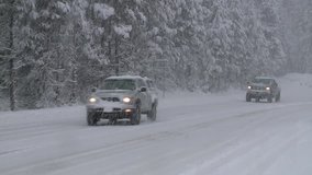 TRAFFIC COMMUTE IN HEAVY SNOW STORM IN THE CALIFORNIA NEVADA SIERRAS 1080 HD 1920X1080  HIGH DEFINITION STOCK VIDEO CLIP