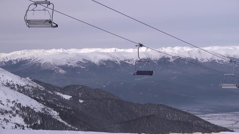 Skiers and snowboarders on a chairlift of ski resort Bansko