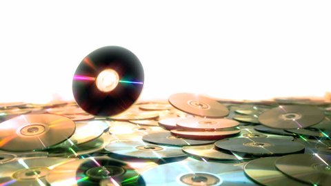 Optical Discs falling onto big pile of DVDs or CDs
