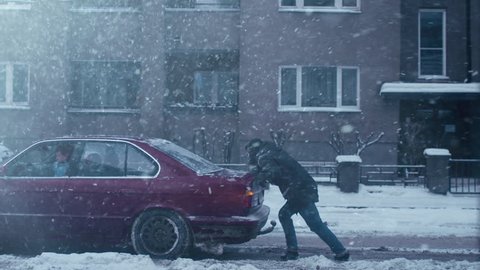 Man is pushing broken down car at winter time. Shot on RED Digital Cinema Camera in 4K (UHD), so you can easily crop, rotate and zoom, without losing quality.
Used ProRes format.