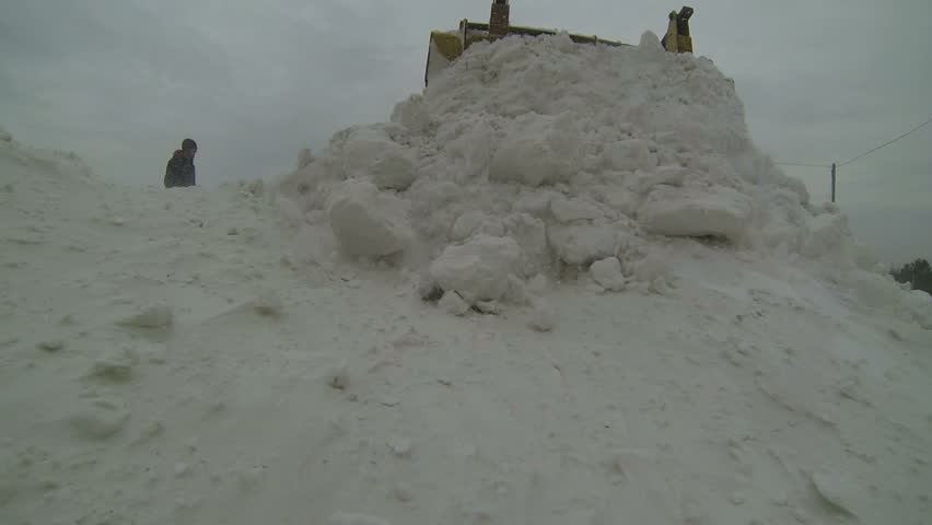 Snow Removing Equipment in Action.
Snow plow clearing road during heavy snowfall.
