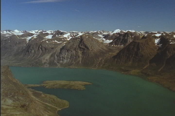 Baffin Island, Pangnirtung Fjord aerial turn. The water is green from the ice melt.