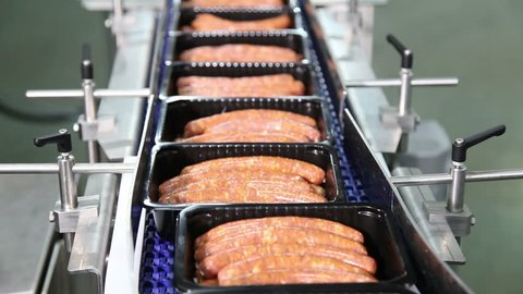 sausages in the black box on the production line