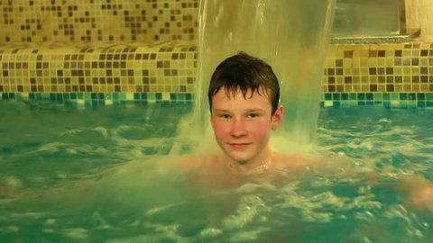 teenager in a small indoor pool in the sauna
