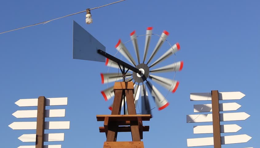 Antique style farmer windmill spins and moves with the wind.