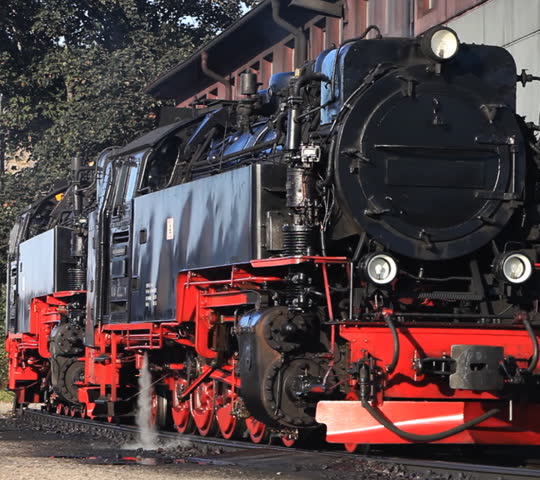 Old vinage steam trains with steam and smoke in shunting yard 
