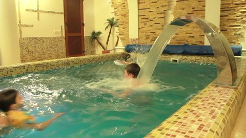 boys having fun swimming in the little pool
