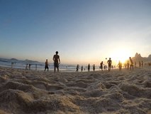 Silhouettes of Carioca Brazilians playing altinho beach football at Posto Nove sunset on Ipanema Beach Rio de Janeiro Brazil