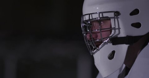 Close up of Goalie's face through his mask blowing steam. Stock Video