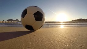 Rio de Janeiro Brazil soccer football golden sunrise with lapping waves on Copacabana Beach