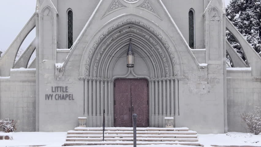 Slow zoom out of the front door of a historic chapel in winter. HD 1080p.