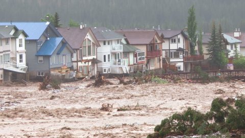 Flood waters threatening a housing development, Canmore, Alberta, Canada