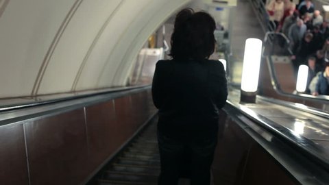 People going down the subway escalator