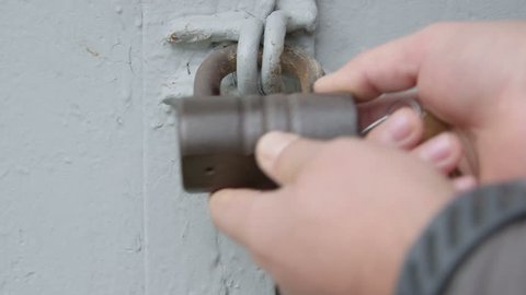 Hand locking padlock on metal gates