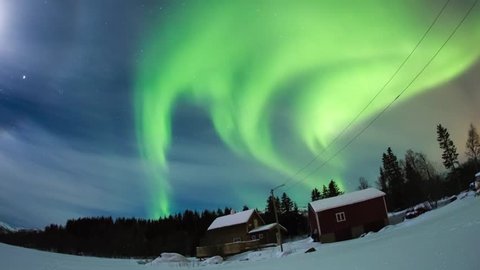 Northern lights dancing on a typical house in Norway.