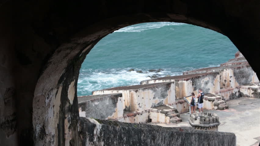 Castillo San Felipe del Morro Fort San Juan tunnel walk. Couple enjoy historical tour of architecture and building. Morro Castle, a 16th century citadel. Built in 1539 by Spain to protect Puerto Rico.