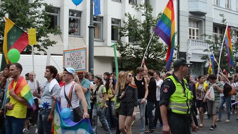 big gay parade crowd marching down the street with flags balloons. Annual Baltic pride parade on July in Vilnius, Lithuania.