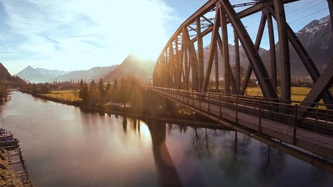 sunset background. bridge over water. aerial view. fly over. river water reflection. rail road street. transportation traffic. 1920x1080