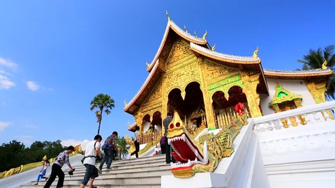 LUANG PRABANG, LAOS - CIRCA JAN 2014: Tourists visit Royal Palace(Haw Kham) & Haw Pha Bang, on circa January, 2014,  Luang Prabang, Laos.  Luang Prabang is a UNESCO World Heritage Site. 
