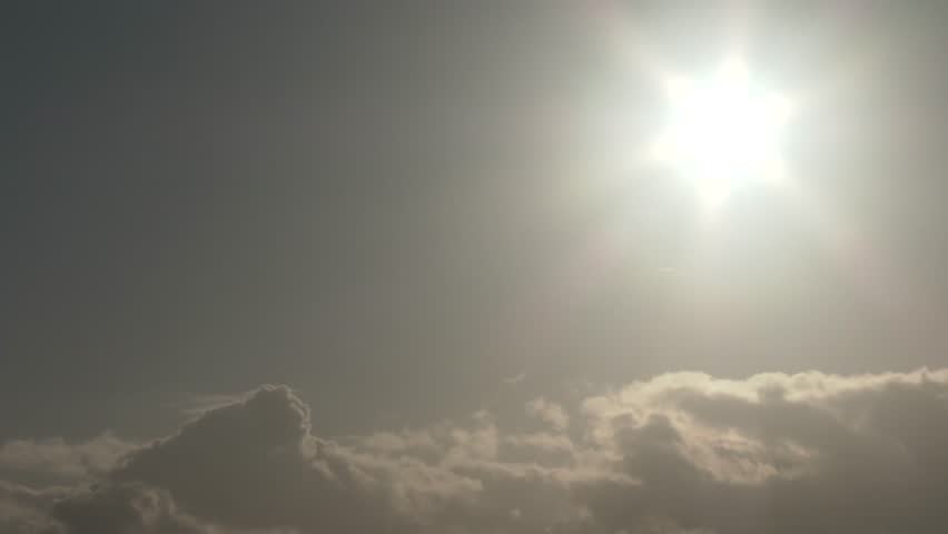 4K Airplane crossing sun at sunset