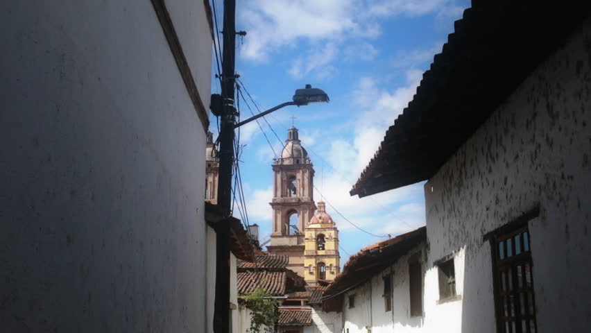 Narrow street  leads to the main church in Mexico