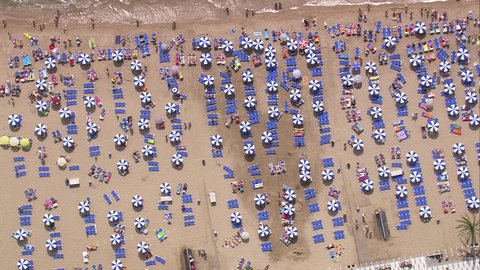 Beach in Spain - Top down shot of umbrellas, loungers and bathers on beach in Spain