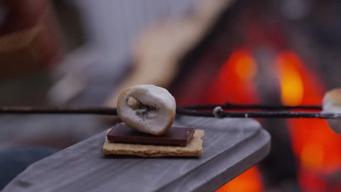 Making smores by outdoor fire. Shot on RED EPIC for high quality 4K, UHD, Ultra HD resolution.