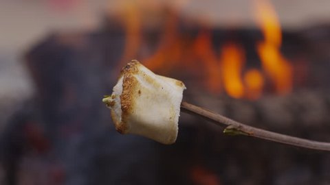 Roasted marshmallow by campfire. Shot on RED EPIC for high quality 4K, UHD, Ultra HD resolution.