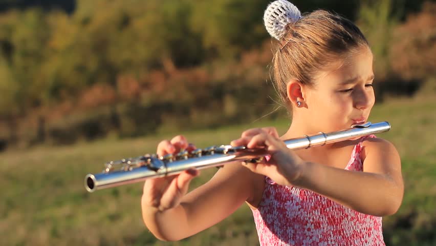 little girl plays flute outdoors Stock Footage Video (100% Royalty-free) 56...